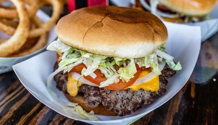 Cheeseburger topped with lettuce, tomato, onion and melted American cheese at Bill's Burgers, Wings and Things in Burnet, TX